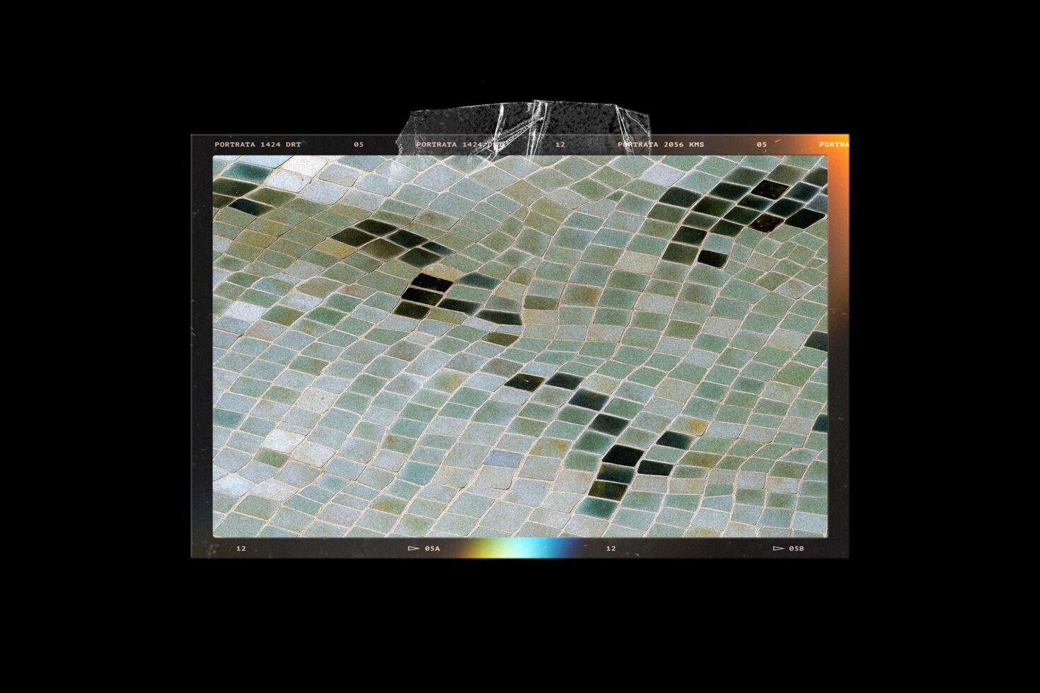 Aerial photo of geometric farmland with green, white, tan squares arranged in diagonal pattern
