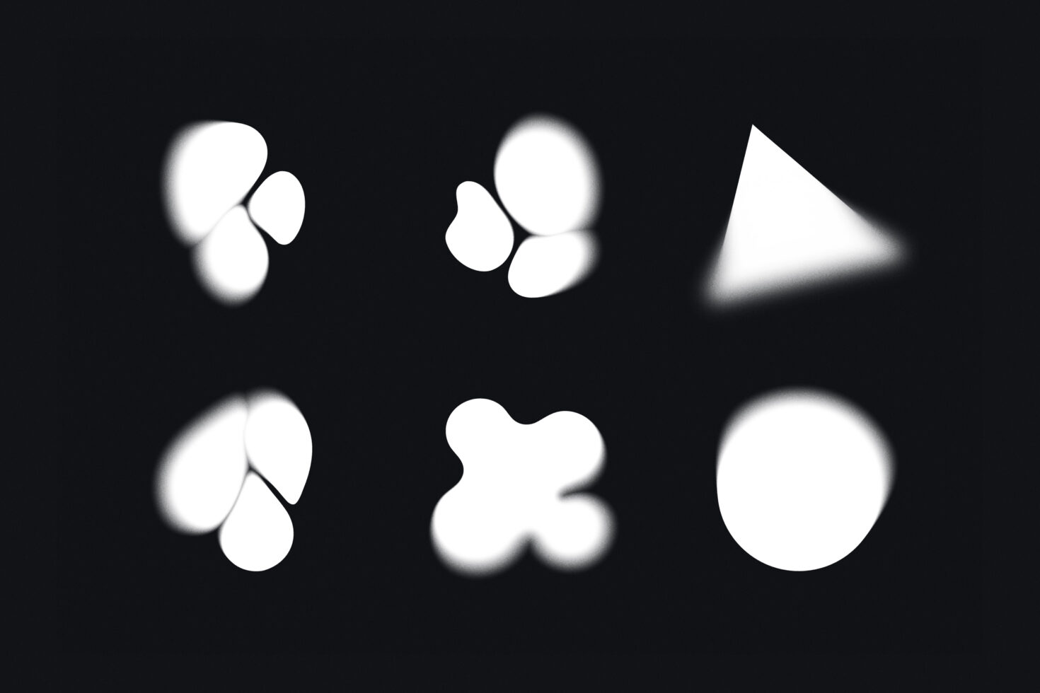 Six blurred white shapes on black background, organic blob forms with soft edges