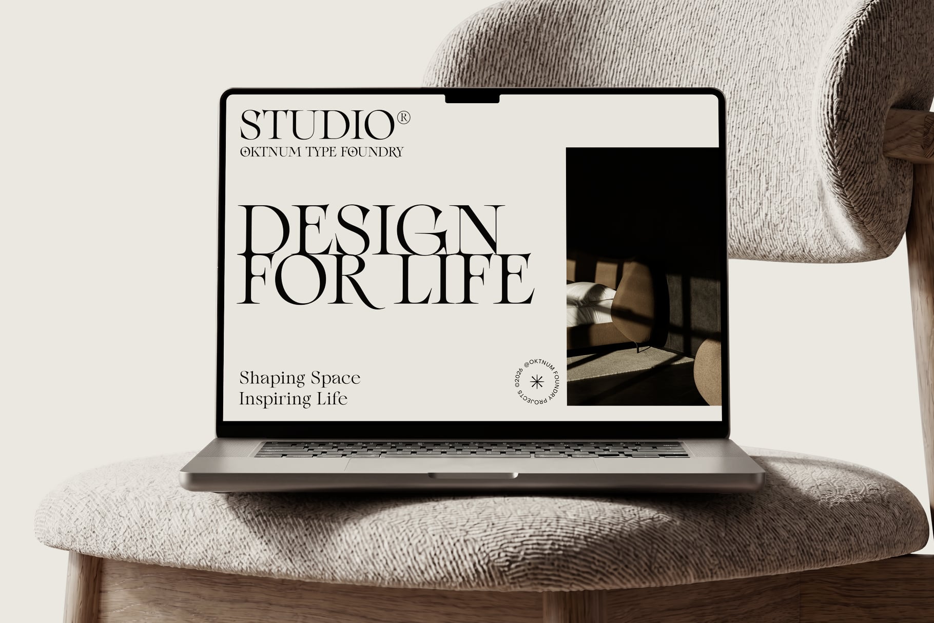 Laptop mockup showing minimalist design website on cream chair with natural light streaming across screen