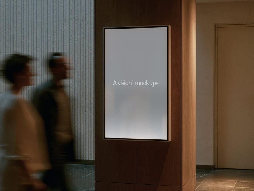 Vertical display screen in modern lobby with blurred people walking by