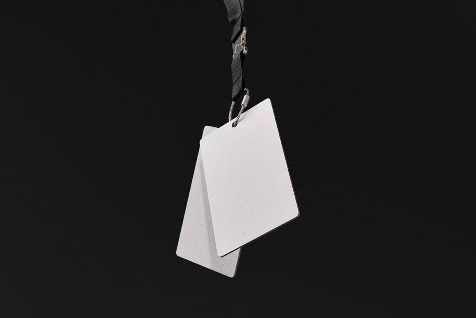 Blank ID badge hanging from black lanyard against dark background