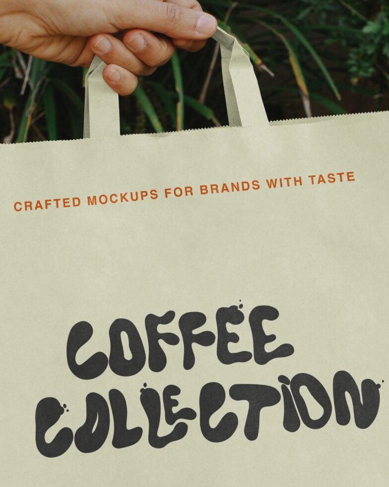 Hand holding cream canvas tote bag with "Coffee Collection" text, green plants in background