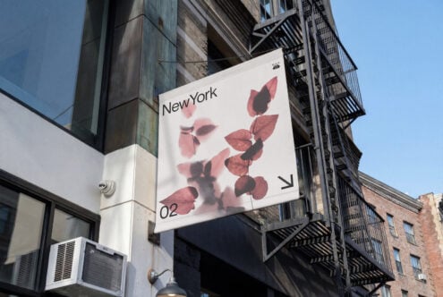 Street sign mockup with blurred red leaves, New York typography, mounted on urban building facade