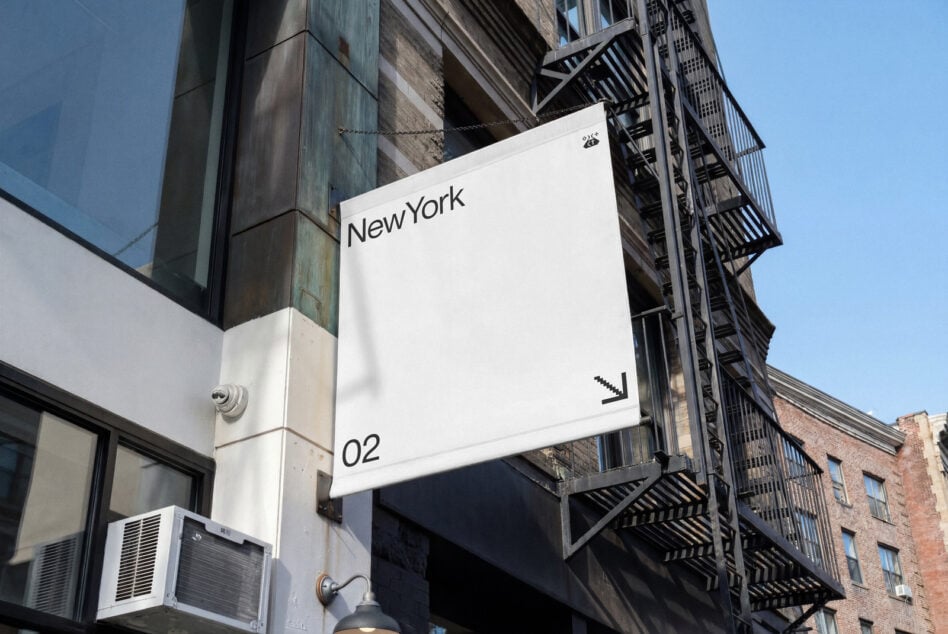 White square signage mockup hanging on industrial NYC building facade