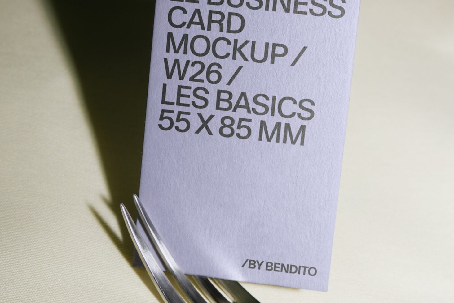 Stacked business cards in lavender showing mockup specs with metal ring binding detail