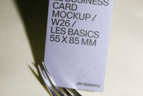 Stacked business cards in lavender showing mockup specs with metal ring binding detail