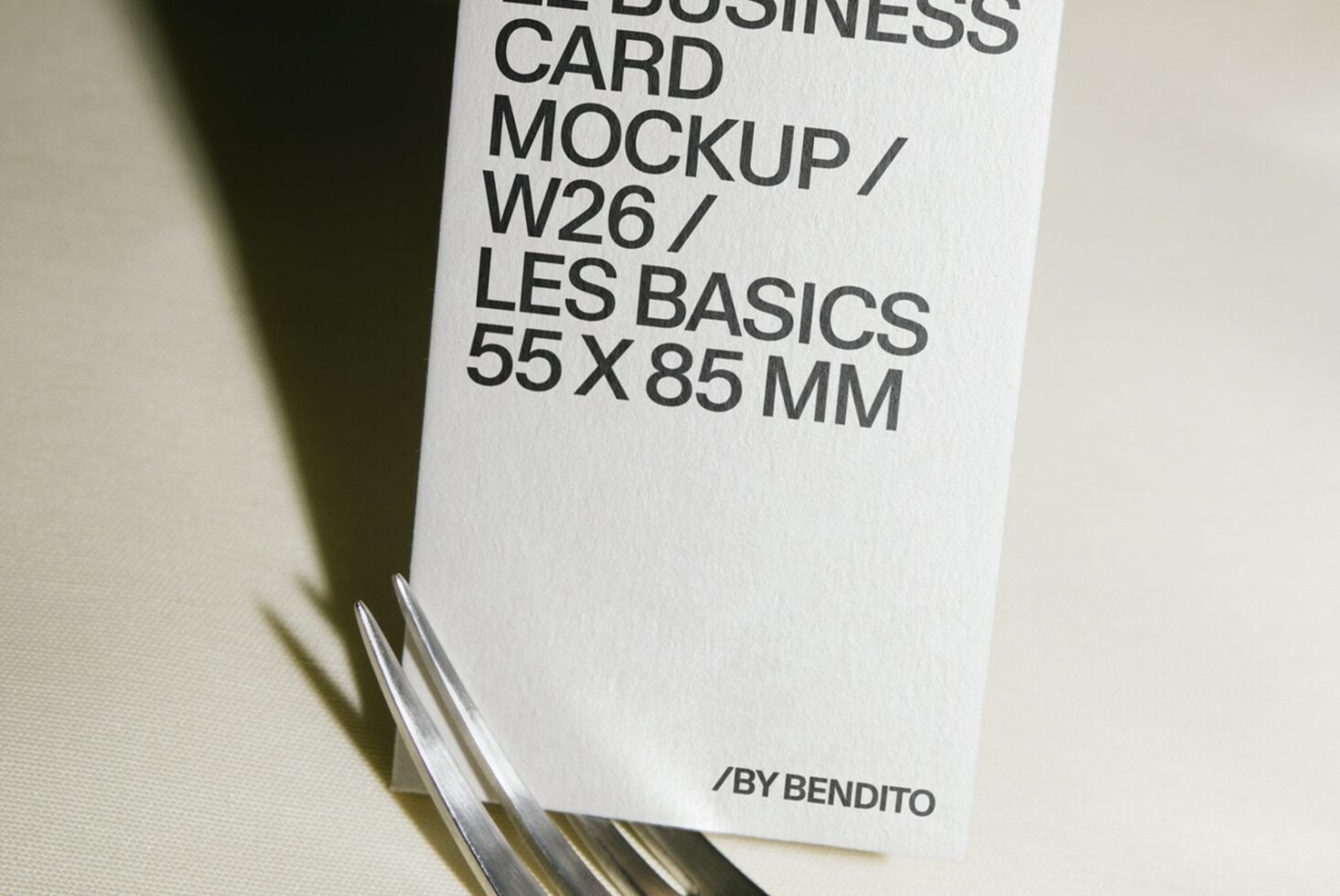 Stacked business cards mockup showing clean white card with black typography on neutral background