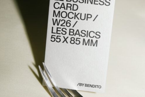 Stacked business cards mockup showing clean white card with black typography on neutral background
