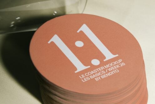 Stack of terracotta coasters with minimalist white logo print on top coaster