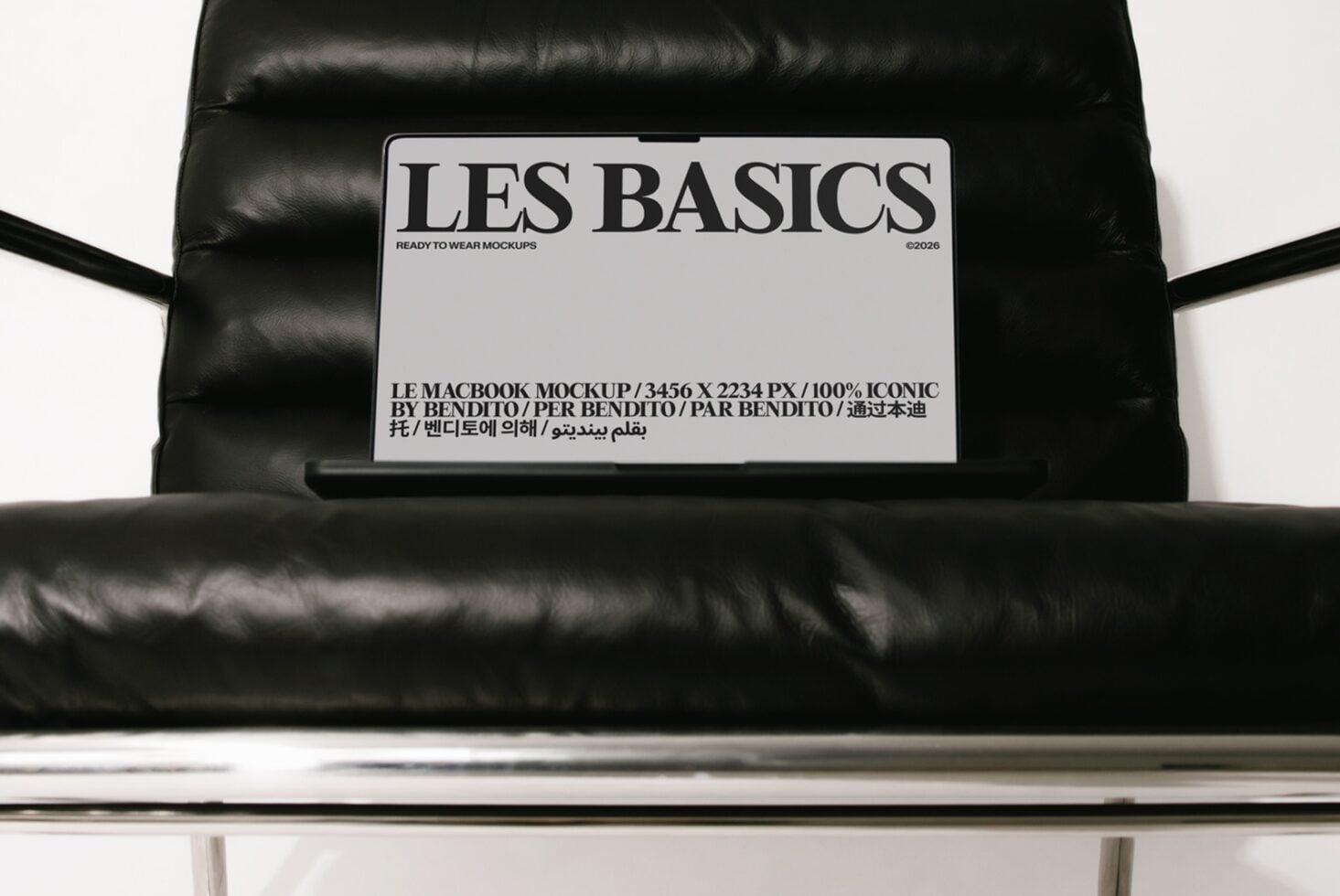 Les Basics MacBook mockup on black puffer jacket with multilingual label details