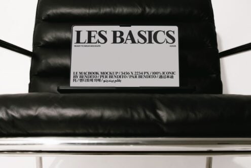 Les Basics MacBook mockup on black puffer jacket with multilingual label details