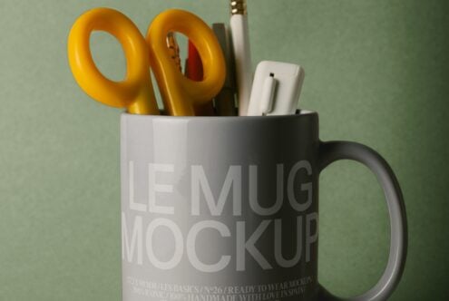 Mug mockup styled with yellow scissors, pens, plus sage green backdrop