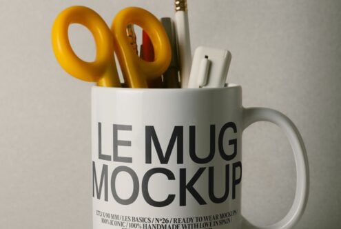White mug mockup filled with gold scissors, pens, plus other desk stuff on neutral background