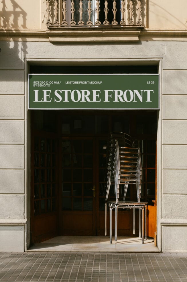Storefront mockup with green signage on cream facade, metal chairs stacked inside