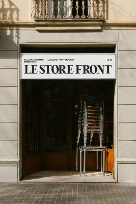 Minimalist storefront mockup with bold serif signage on white band, stacked metal chairs visible through dark window