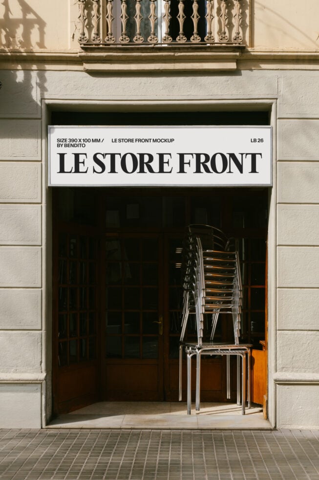 Minimalist storefront mockup with bold serif signage on white band, stacked metal chairs visible through dark window