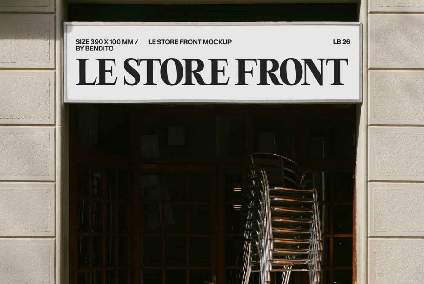 Minimal storefront sign mockup with bold serif lettering on cream background, stacked chairs visible through dark window below