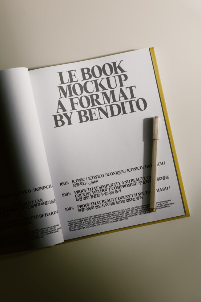 Open book mockup with gold spine showing typography layout on white pages