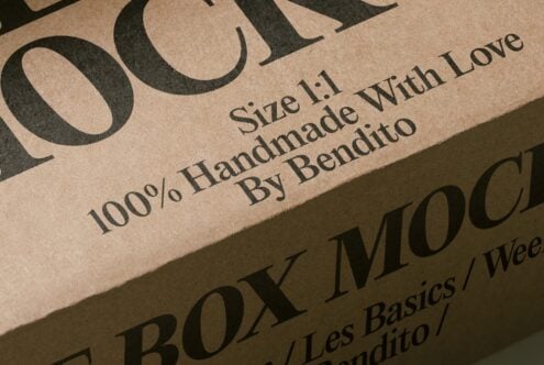 Close-up of kraft paper packaging with serif typography showing size, handmade label, designer name