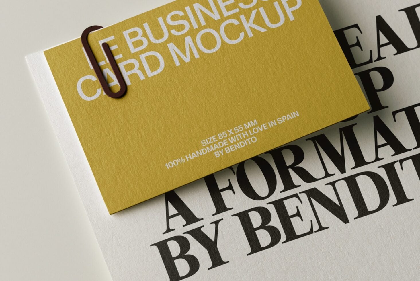 Gold business card mockup with burgundy paperclip, white edge detail, handmade in Spain