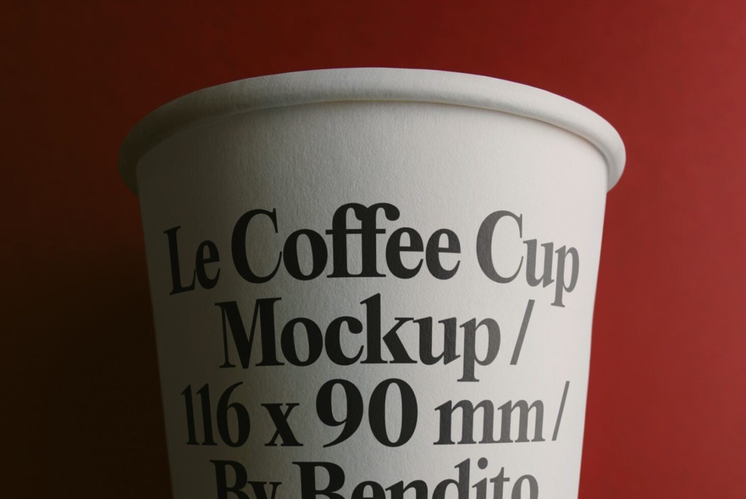 White paper cup mockup with serif typography on deep red background, close-up view
