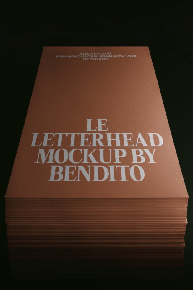 Stack of terracotta letterhead mockups with embossed silver text showing brand details