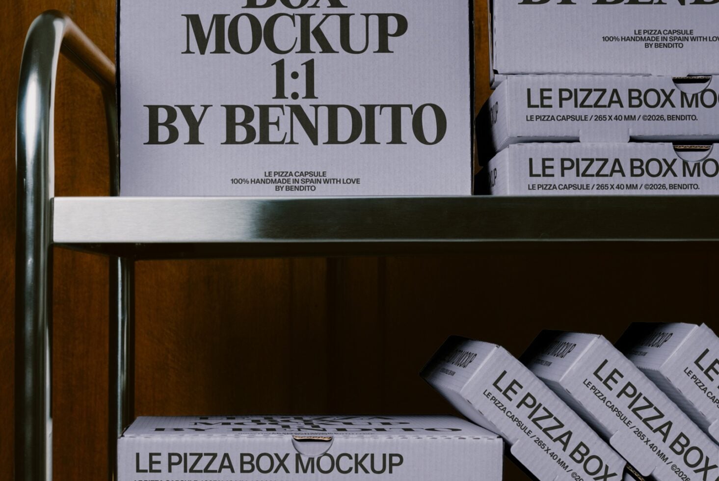 Pizza box mockup staged on wooden shelf with metal rail, stacked boxes showing branding from Bendito