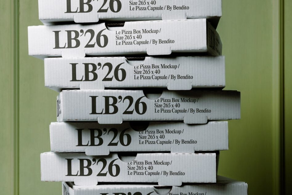 Stacked white pizza boxes with bold serif typography against soft green background