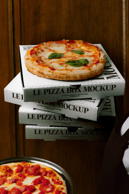 Stacked pizza boxes mockup with fresh margherita pizza on top, wood backdrop