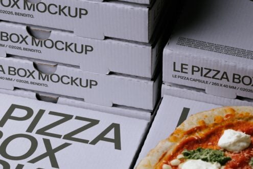 Stacked pizza boxes with bold typography next to a fresh slice with tomato sauce, mozzarella, basil