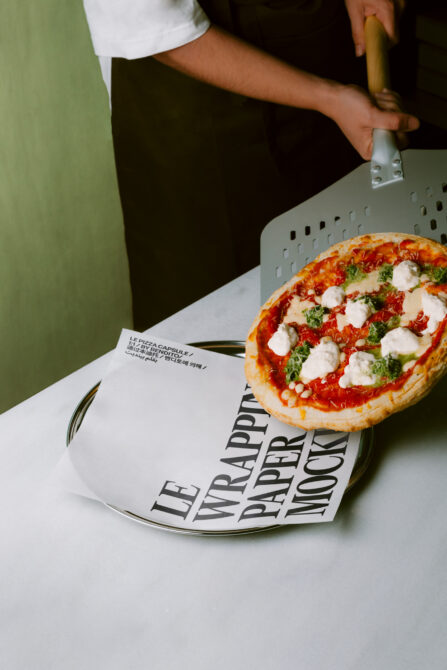 Pizza plate mockup with fresh margherita, styled food photography against green wall background