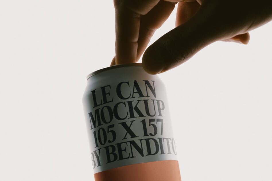 Hands holding white aluminum can mockup with black text, orange bottom band, bright studio lighting