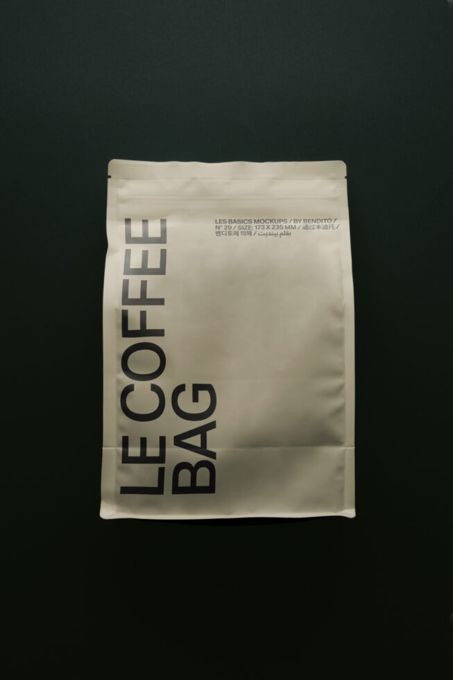 Cream pouch with bold Le Coffee Bag typography on dark background mockup