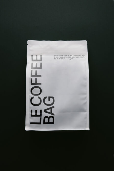 White coffee bag mockup with bold vertical typography on dark background