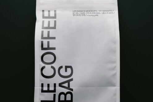 Folded white paper with bold sans serif type reading "LE BASICS BAG" rotated vertically