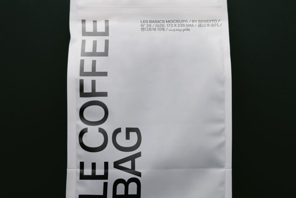 Folded white paper with bold sans serif type reading "LE BASICS BAG" rotated vertically