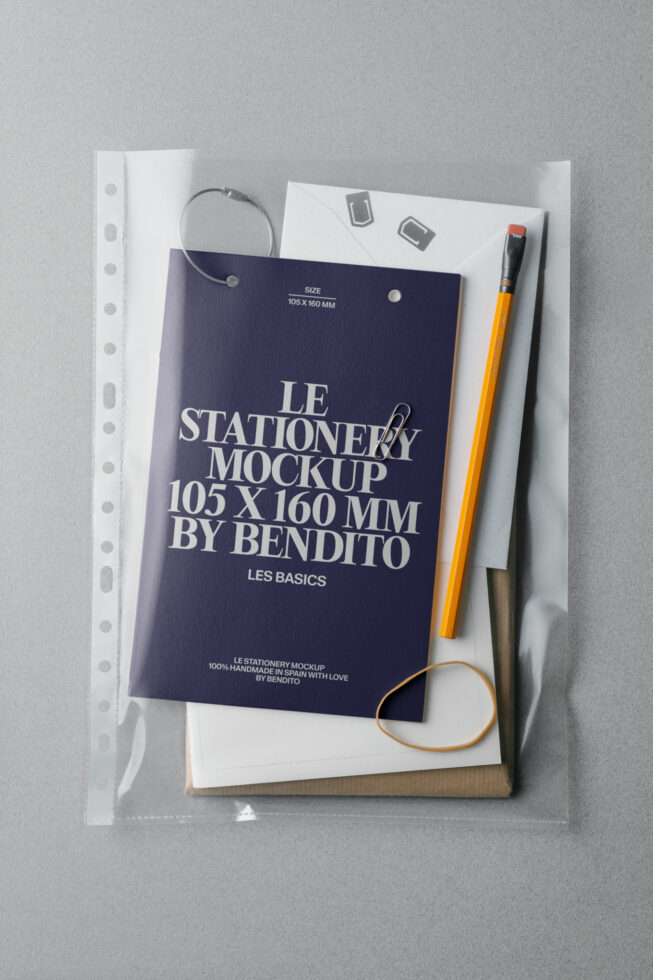 Dark navy stationery card mockup 105x160mm with pencils, clips, rubber bands scattered on white surface