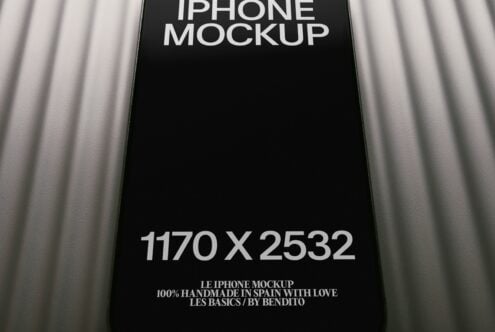 Black iPhone mockup with draped fabric background, clean screen space for designs