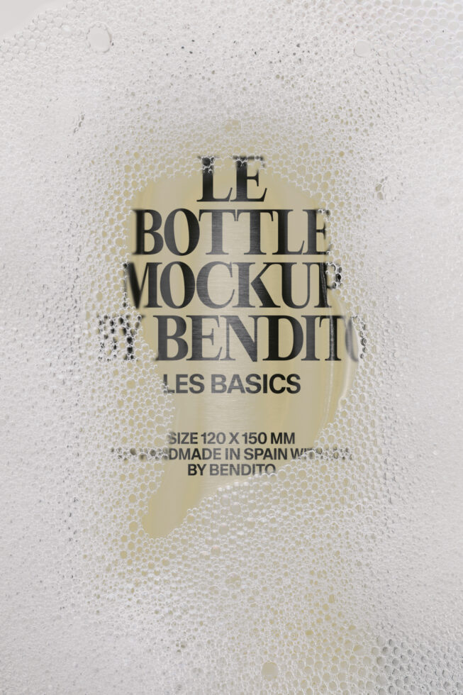 Bendit bottle mockup surrounded by bubble wrap, cream label showing Les Basics branding with size specs