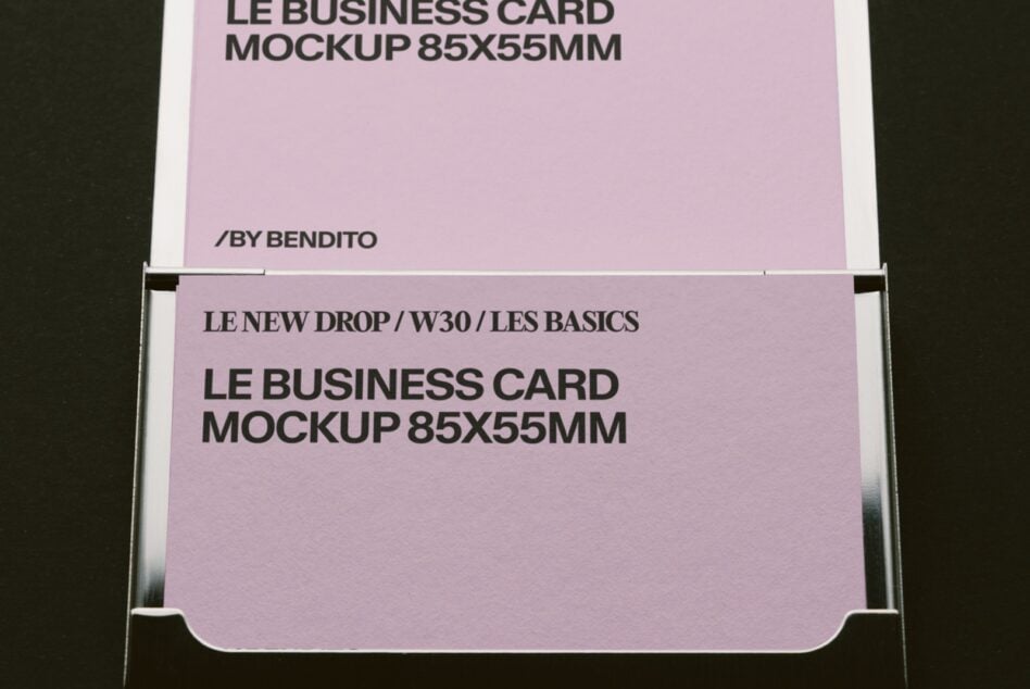 Stacked pink business cards in metal holder showing 85x55mm mockup template