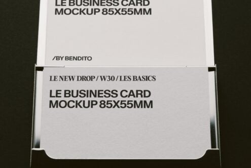 Stacked business cards in holder showing front, back, edge with black text on white stock