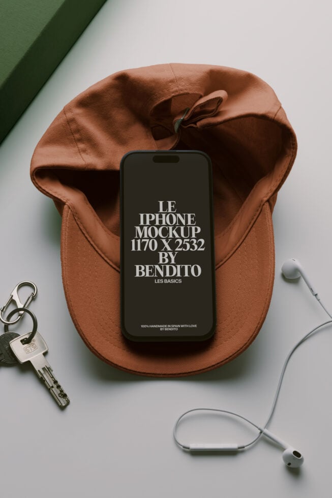 iPhone mockup on terracotta pouch with keys, earbuds, minimal aesthetic styling