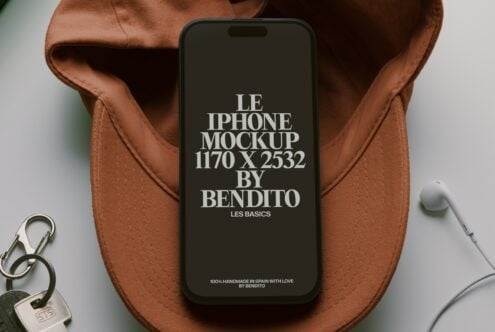 iPhone on terracotta fabric with keys, earbuds nearby, clean minimalist styling