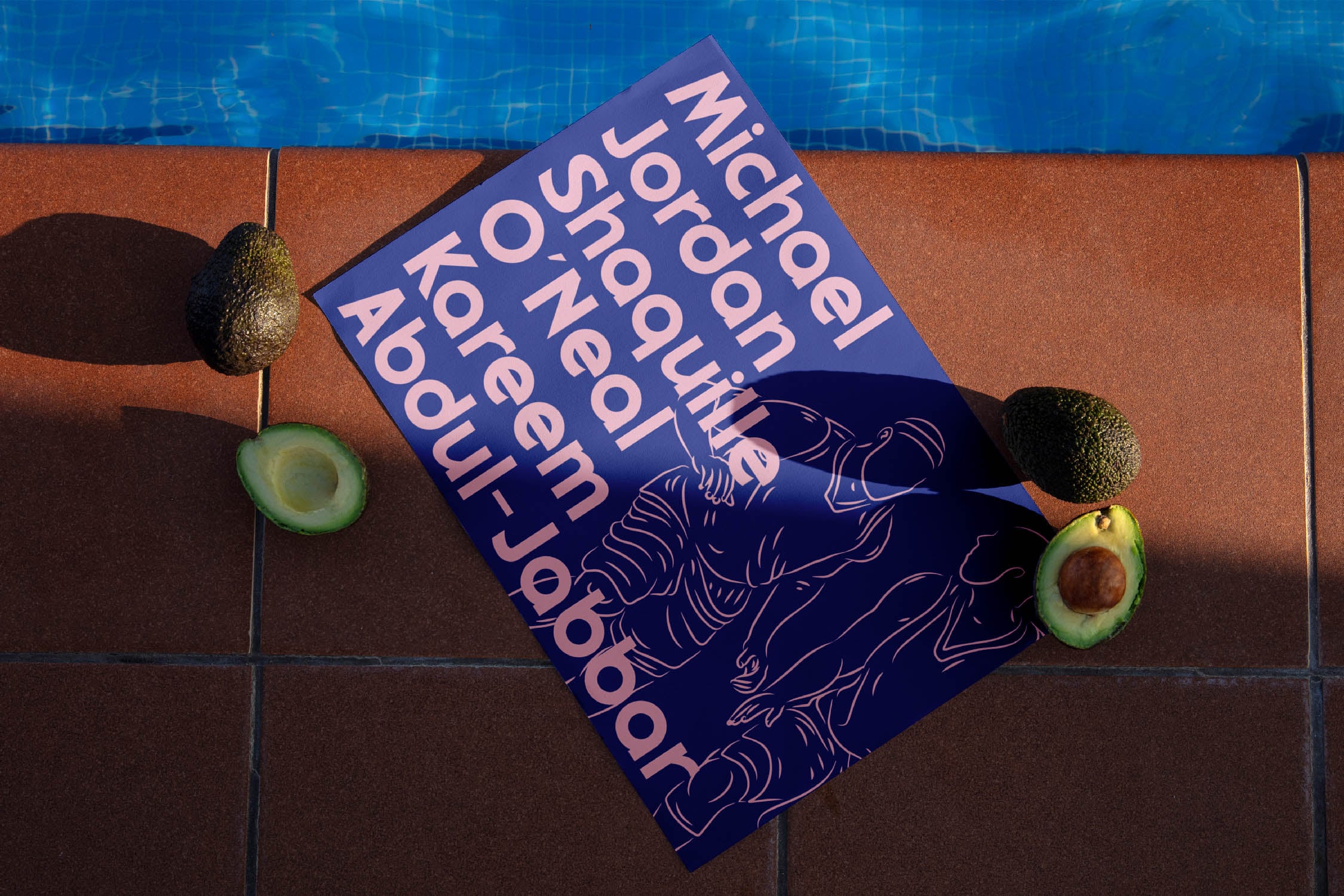 Blue magazine mockup sprawled on terracotta tiles with avocados, pool water backdrop