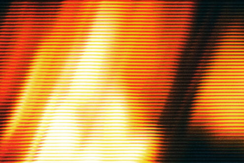 Glowing neon lines radiating from center with red, orange, yellow fading to black edges