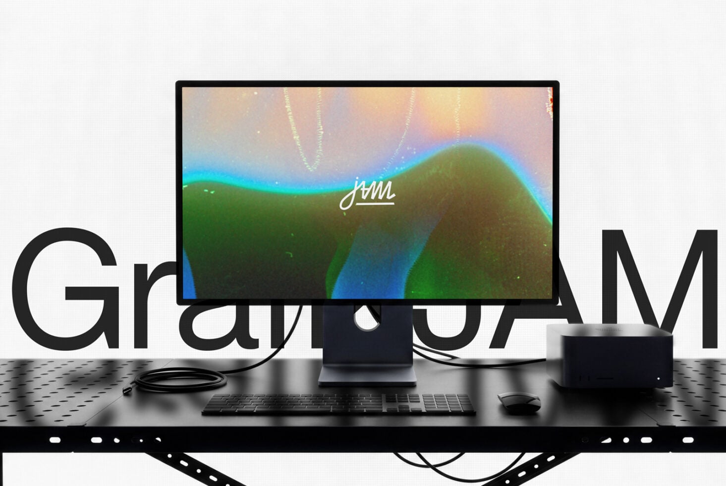 Desktop setup mockup showing monitor with colorful gradient wallpaper, keyboard, mouse, speakers