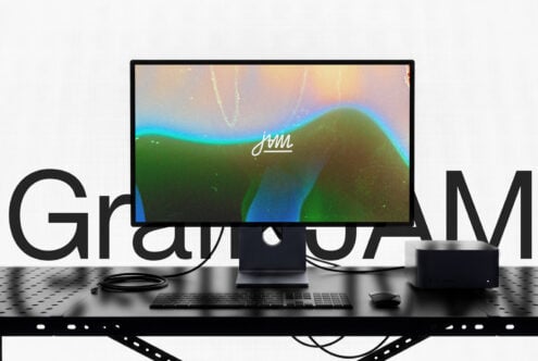 Desktop setup mockup showing monitor with colorful gradient wallpaper, keyboard, mouse, speakers