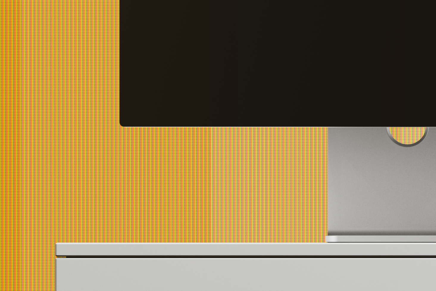 Retro striped pattern in yellow, orange, green with silver laptop mockup on gray surface