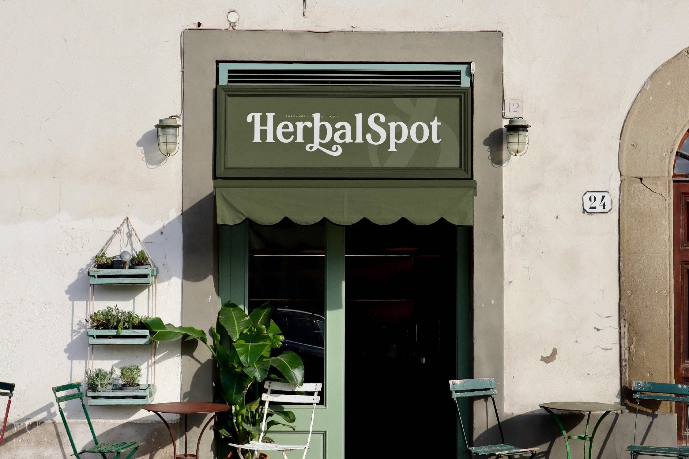Charming storefront with green awning, hanging plants, bistro chairs, HerbalSpot signage