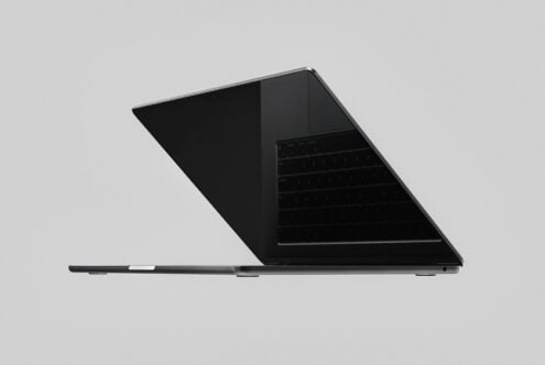 Sleek black laptop mockup angled side view with dark screen on neutral background